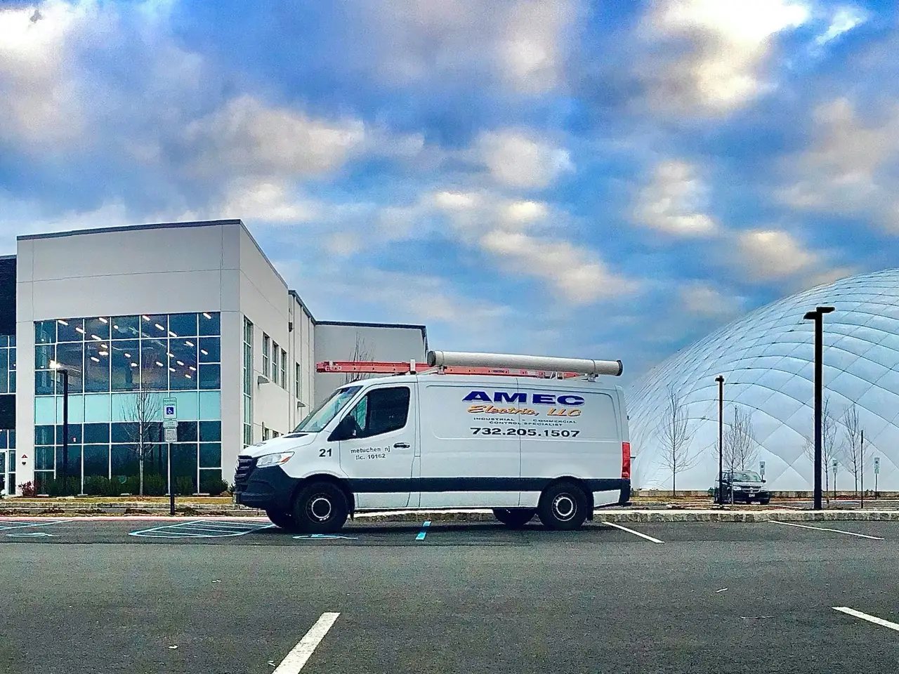 AMEC Electric service truck at a commercial job site